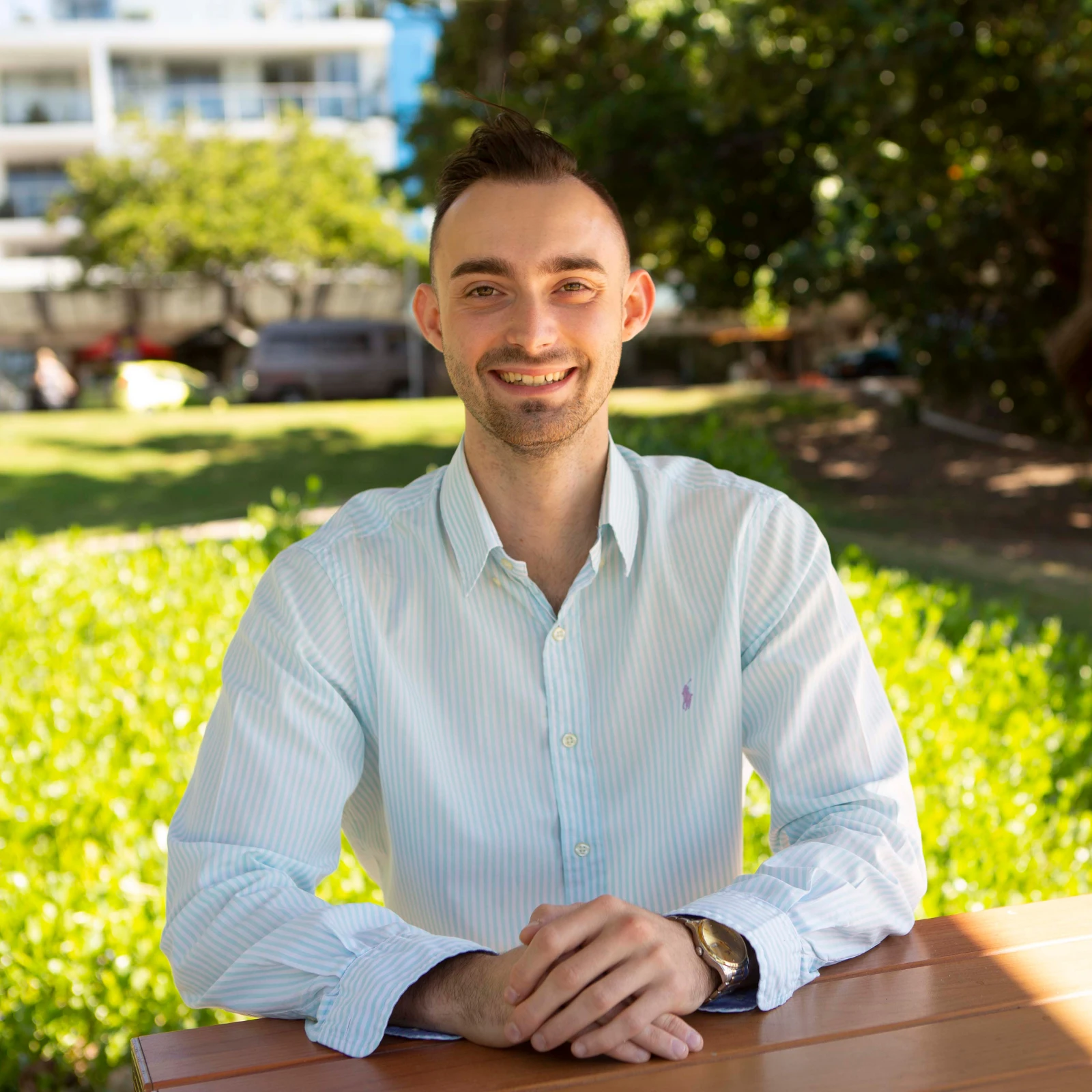 Harrison, founder of Off Leesh, sitting outdoors